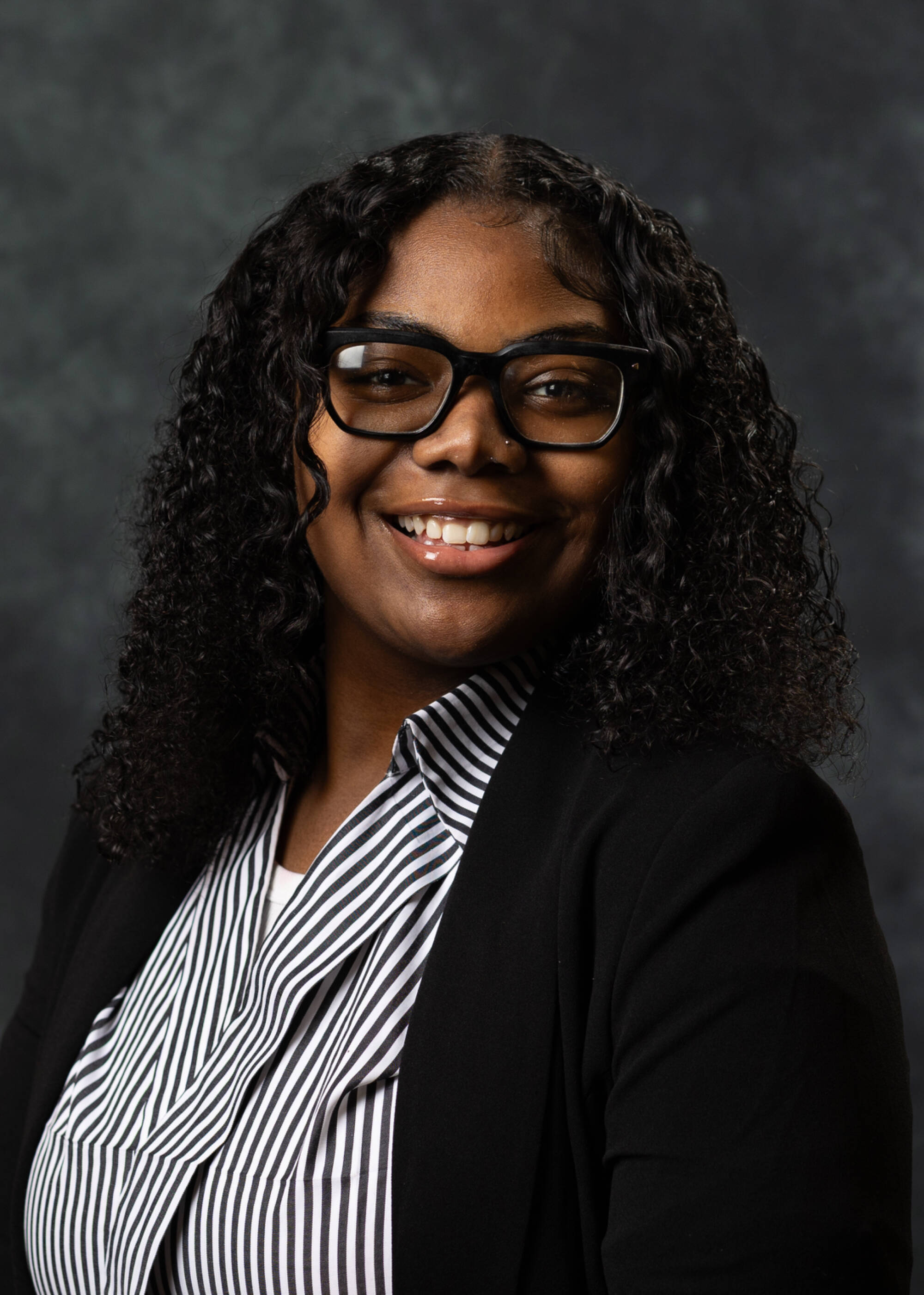Kayla Finley smiling in a black blazer